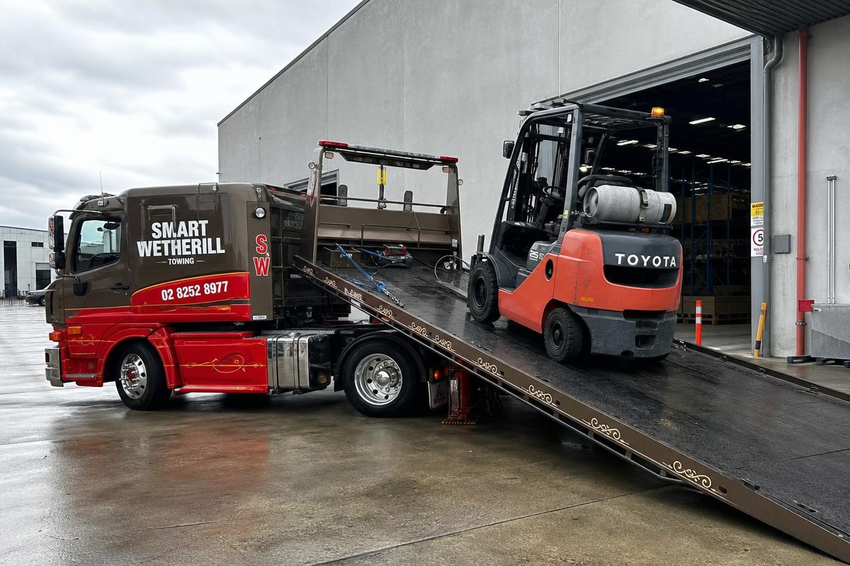 Forklift being loaded onto a Smart Wetherill Towing tow truck