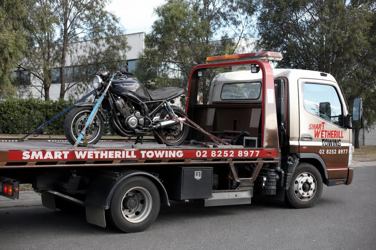 Motorbike strapped to a Smart Wetherill Towing tow truck